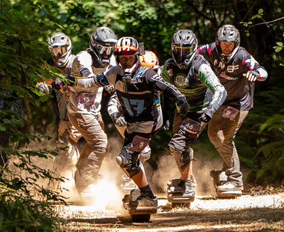 Onewheel racers packing a forest trail