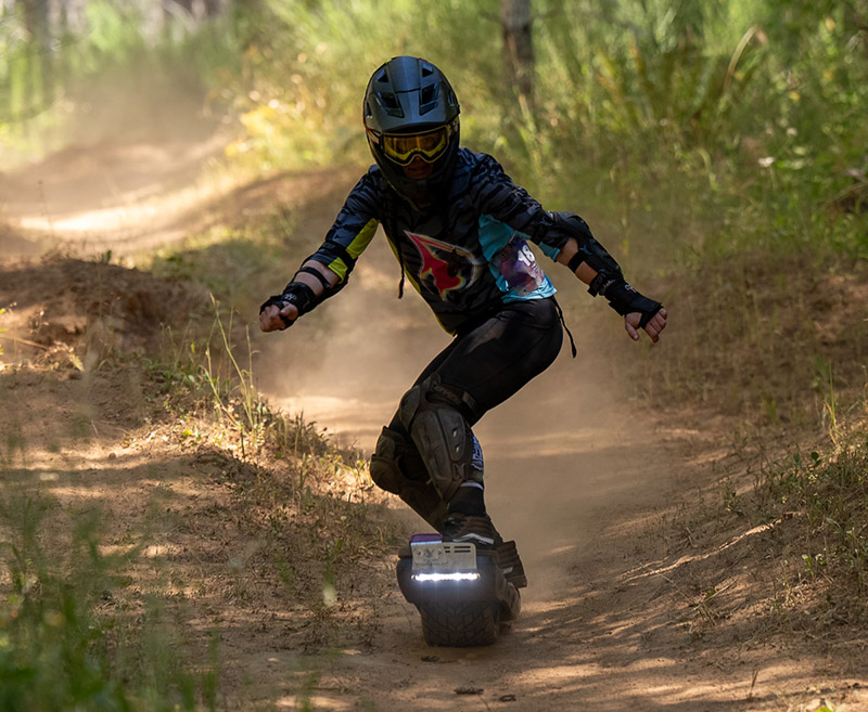Onewheel rider on a technical trail